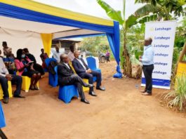 Roger Mugisha (Head Corporate Communications) speaks to Letshego directors Peter Masaba, CEO Aijukwe Giles and the farmers during the official handover of ILC Poultry project in Wakiso yesterday